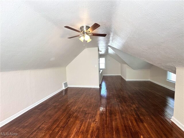 19708 Sunset Dr, Warrensville Heights, OH 44122 - additional living space featuring a textured ceiling, hardwood / wood-style floors, ceiling fan, baseboards, and lofted ceiling