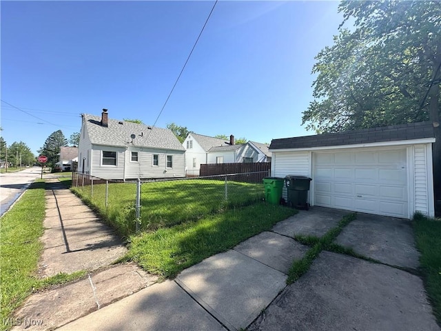 19708 Sunset Dr, Warrensville Heights, OH 44122 - view of side of home with driveway, an outdoor structure, and a garage