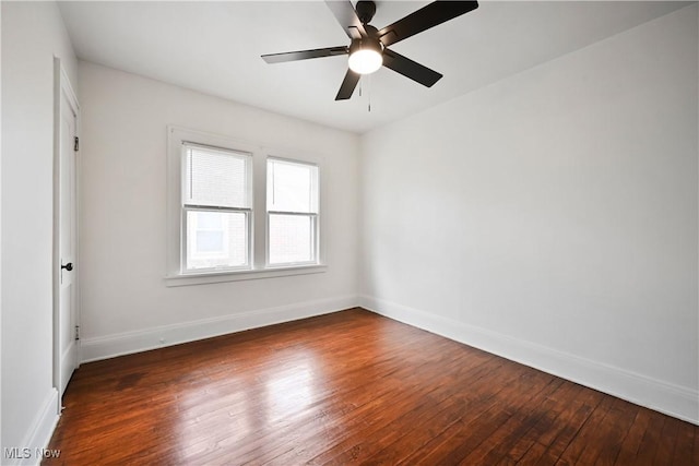 unfurnished room featuring hardwood / wood-style floors, baseboards, and a ceiling fan