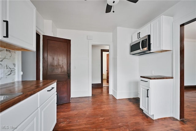 kitchen with stainless steel microwave, ceiling fan, dark wood finished floors, and tasteful backsplash