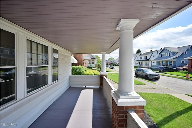 wooden deck with a porch and a residential view