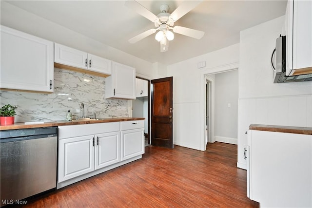 kitchen featuring appliances with stainless steel finishes, a sink, white cabinetry, a ceiling fan, and wood finished floors