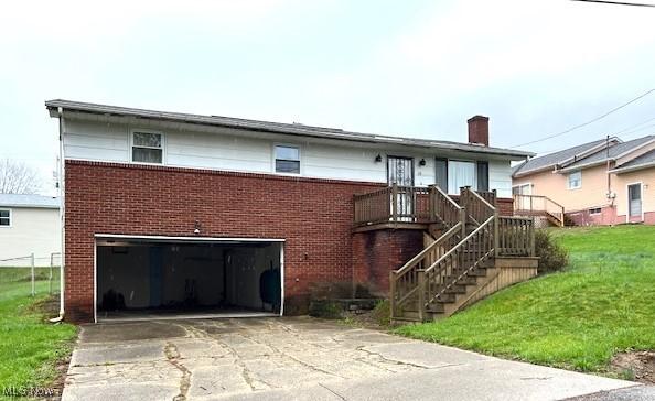 116 Brentwood Blvd, Wintersville, OH 43953 - view of front of property featuring brick siding, a garage, concrete driveway, a chimney, and a front lawn