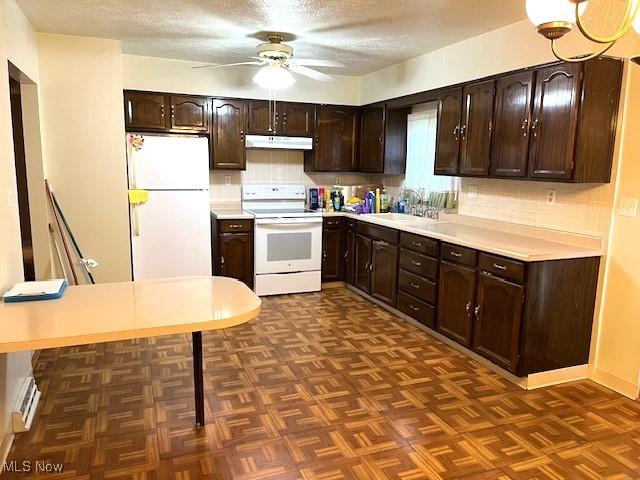 116 Brentwood Blvd, Wintersville, OH 43953 - kitchen featuring white appliances, under cabinet range hood, dark brown cabinetry, backsplash, and a textured ceiling