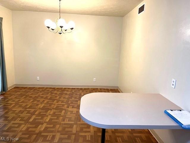 116 Brentwood Blvd, Wintersville, OH 43953 - unfurnished dining area featuring a chandelier, baseboards, and a textured ceiling