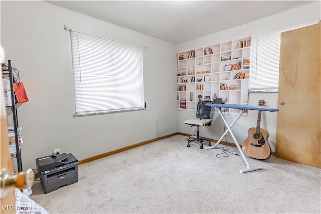 carpeted office featuring baseboards
