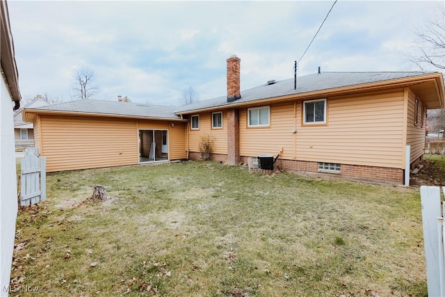 back of property featuring a chimney and cooling unit