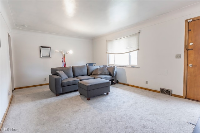 carpeted living room featuring baseboards