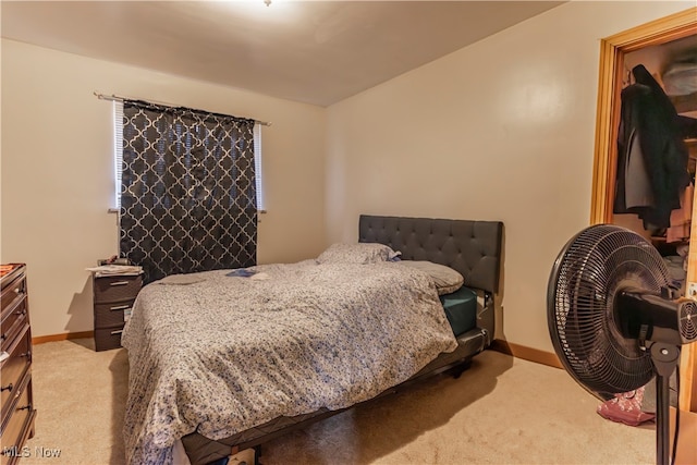bedroom with carpet floors and baseboards