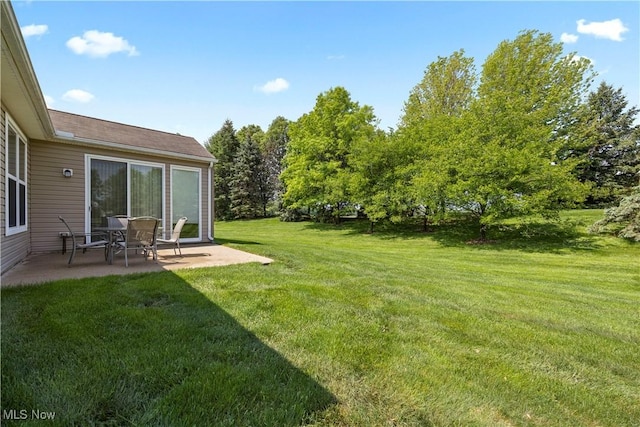 view of grassy yard with a patio