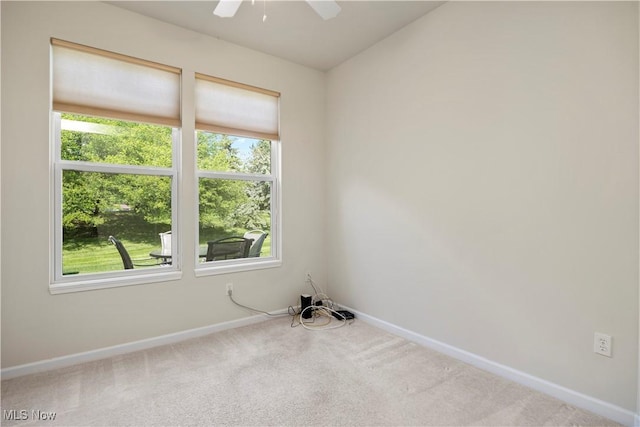 carpeted empty room featuring plenty of natural light, baseboards, and vaulted ceiling