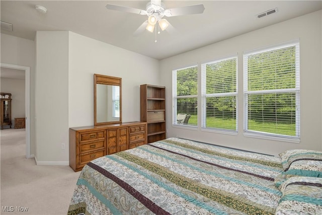 bedroom featuring light carpet, baseboards, and ceiling fan