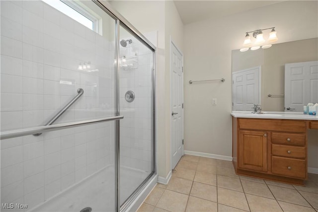 bathroom featuring a shower stall, tile patterned floors, vanity, and baseboards