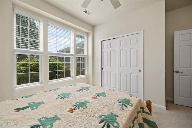 carpeted bedroom featuring a closet, a ceiling fan, and baseboards