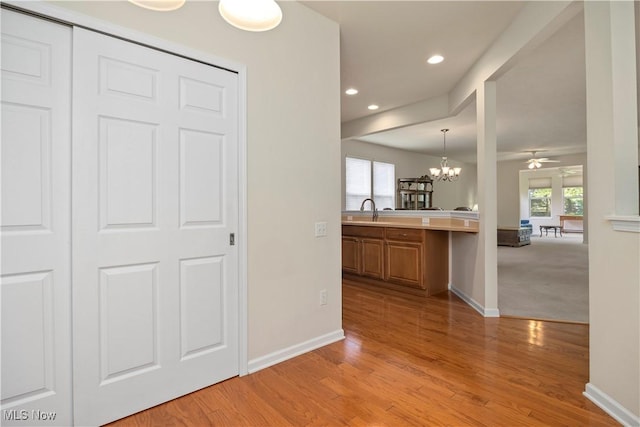 hall with baseboards, light wood-style floors, and recessed lighting