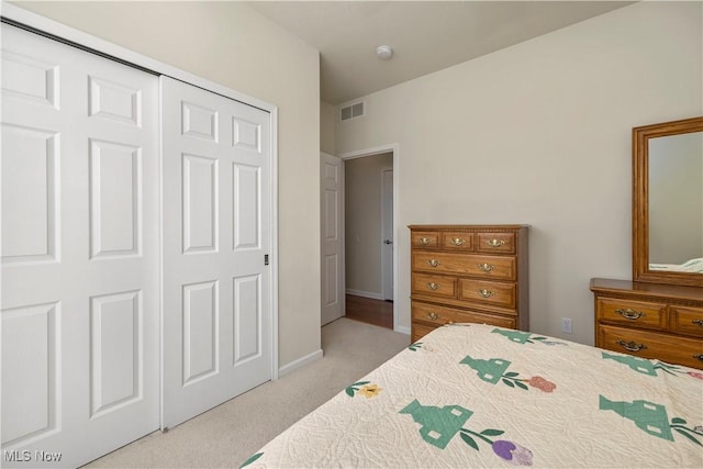bedroom with carpet flooring, a closet, and baseboards
