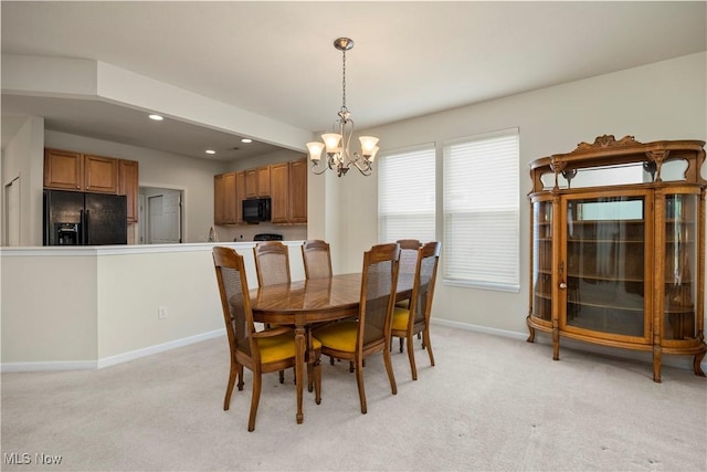 dining room featuring a chandelier, baseboards, light carpet, and recessed lighting
