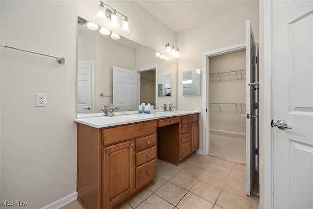 full bathroom featuring double vanity, tile patterned flooring, a spacious closet, and baseboards