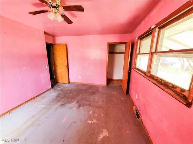 16251 State Route 678, Rockbridge, OH 43149 - unfurnished bedroom with concrete floors, baseboards, and ceiling fan