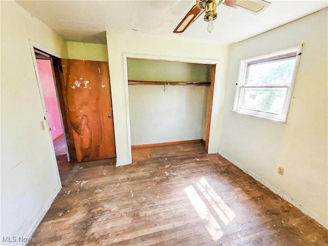 16251 State Route 678, Rockbridge, OH 43149 - unfurnished bedroom with hardwood / wood-style floors, baseboards, ceiling fan, and a closet