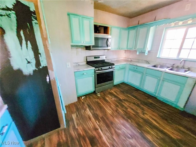 16251 State Route 678, Rockbridge, OH 43149 - kitchen with stainless steel appliances, a sink, dark wood-type flooring, blue cabinets, and light countertops