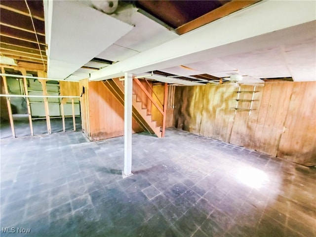 16251 State Route 678, Rockbridge, OH 43149 - unfinished basement featuring wooden walls, stairs, and tile patterned floors