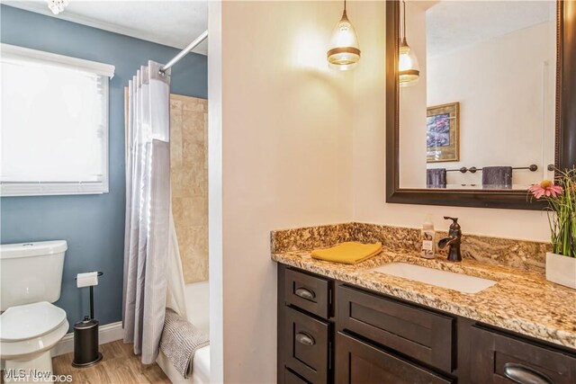 37 Monticello Dr, Brunswick, OH 44212 - bathroom with wood finished floors, vanity, toilet, shower / bath combination with curtain, and baseboards