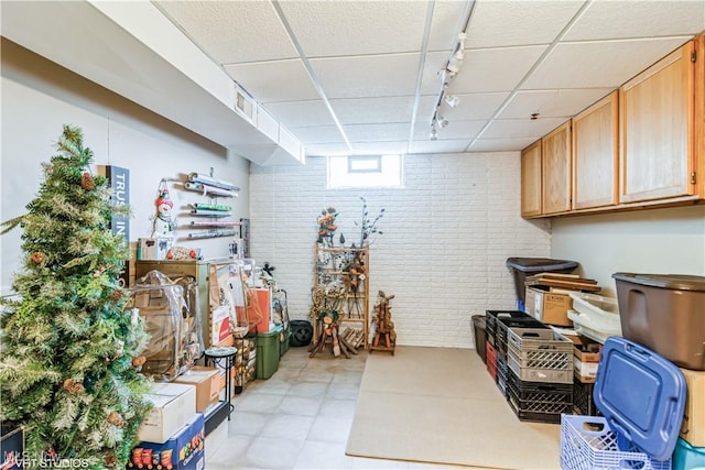 37 Monticello Dr, Brunswick, OH 44212 - basement with track lighting, brick wall, and a drop ceiling