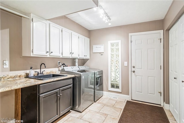37 Monticello Dr, Brunswick, OH 44212 - clothes washing area with washer and clothes dryer, cabinet space, light tile patterned flooring, baseboards, and track lighting
