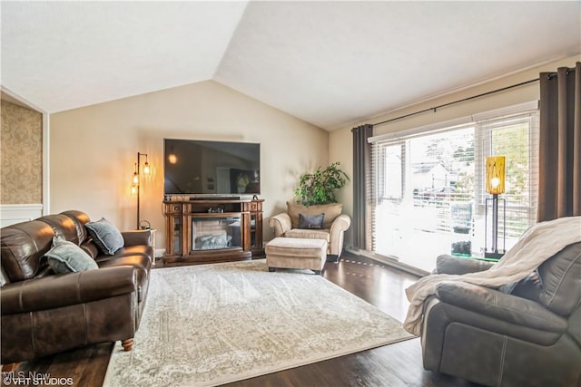 37 Monticello Dr, Brunswick, OH 44212 - living room featuring vaulted ceiling, dark wood finished floors, and a glass covered fireplace