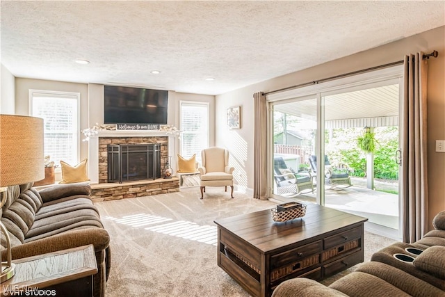 37 Monticello Dr, Brunswick, OH 44212 - living room with carpet, a textured ceiling, a stone fireplace, and recessed lighting