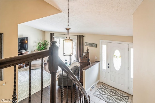 37 Monticello Dr, Brunswick, OH 44212 - foyer featuring a textured ceiling, baseboards, and light tile patterned floors