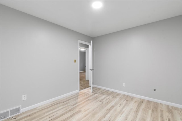 unfurnished room featuring light wood-style floors and baseboards