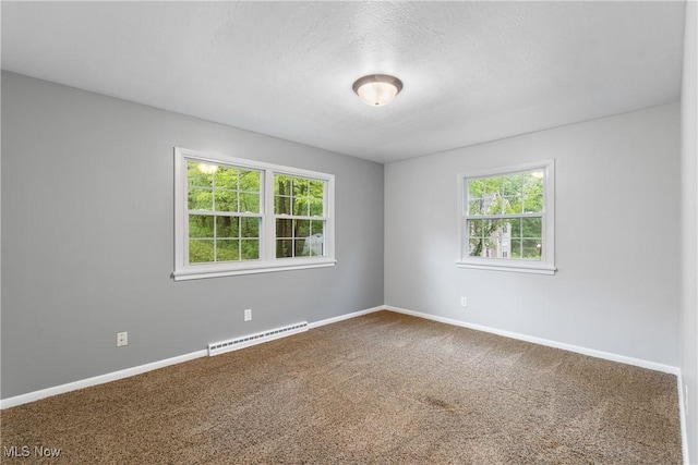 unfurnished room with a baseboard radiator, carpet flooring, and baseboards