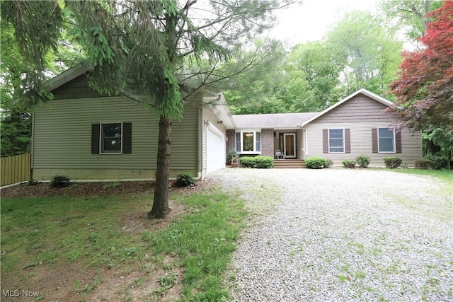 6191 Root Rd, Spencer, OH 44275 - ranch-style home with gravel driveway, a garage, and fence