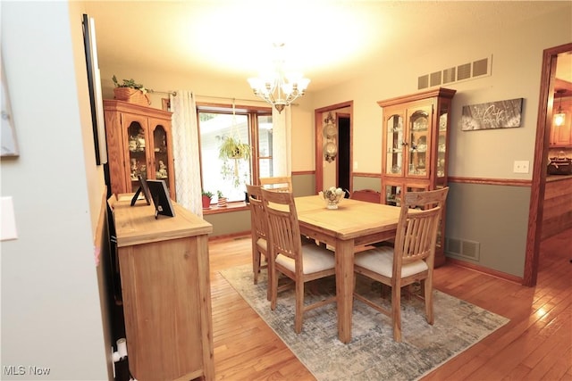 6191 Root Rd, Spencer, OH 44275 - dining area featuring a chandelier, light wood finished floors, and baseboards