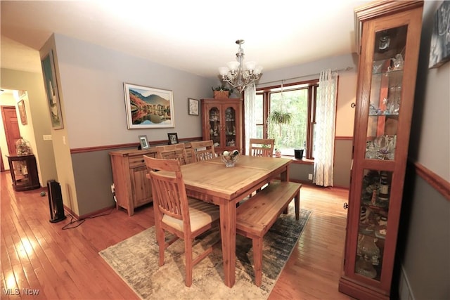 6191 Root Rd, Spencer, OH 44275 - dining room featuring a chandelier, light wood-style flooring, and baseboards