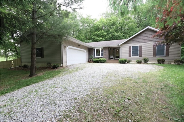 6191 Root Rd, Spencer, OH 44275 - ranch-style home with gravel driveway and an attached garage