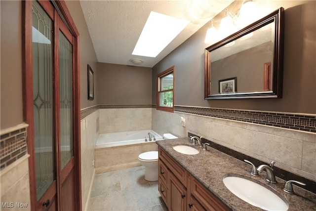 6191 Root Rd, Spencer, OH 44275 - full bathroom with tile walls, a bath, a skylight, toilet, and a textured ceiling