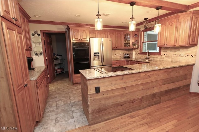 6191 Root Rd, Spencer, OH 44275 - kitchen with black appliances, a peninsula, tasteful backsplash, light stone counters, and pendant lighting