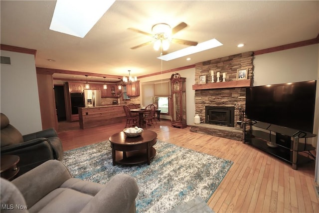 6191 Root Rd, Spencer, OH 44275 - living room with a skylight, a ceiling fan, ornamental molding, and light wood-type flooring