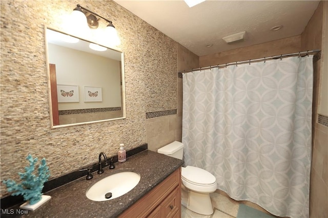 6191 Root Rd, Spencer, OH 44275 - bathroom with tile walls, toilet, vanity, curtained shower, and tile patterned floors