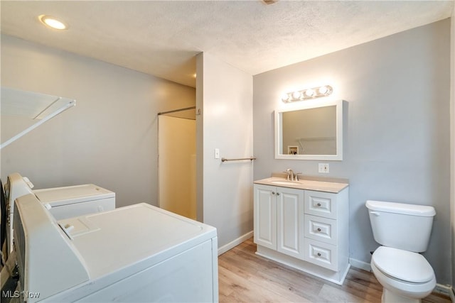 146 E Bergey St, Wadsworth, OH 44281 - full bathroom with independent washer and dryer, wood finished floors, toilet, vanity, and baseboards