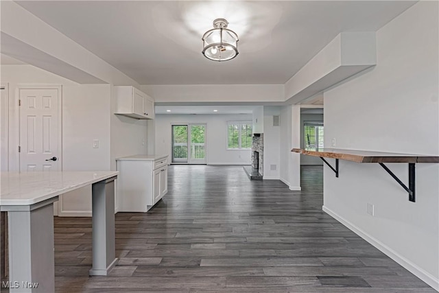 58 W Orange St, Chagrin Falls, OH 44022 - kitchen featuring dark wood-style flooring, white cabinetry, open floor plan, baseboards, and recessed lighting