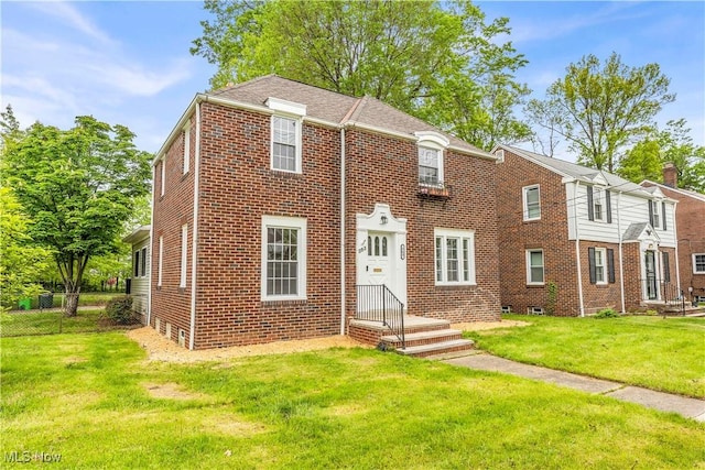 563 E 260th St, Euclid, OH 44132 - view of property with brick siding and a front yard