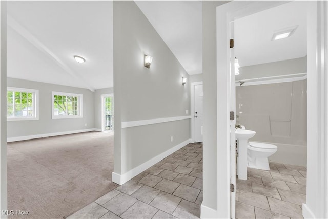 563 E 260th St, Euclid, OH 44132 - bathroom featuring baseboards, toilet, lofted ceiling, tile patterned floors, and shower / bathtub combination