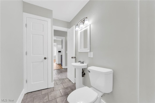 563 E 260th St, Euclid, OH 44132 - bathroom with baseboards, toilet, and tile patterned floors