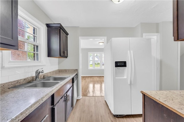 563 E 260th St, Euclid, OH 44132 - kitchen featuring white fridge with ice dispenser, a sink, light wood finished floors, and light countertops