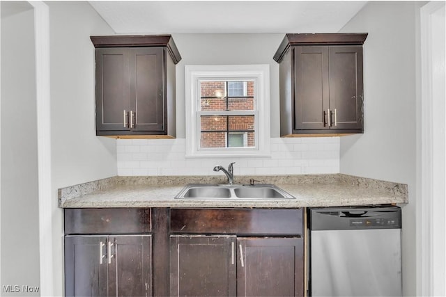 563 E 260th St, Euclid, OH 44132 - kitchen featuring stainless steel dishwasher, a sink, dark brown cabinetry, light countertops, and tasteful backsplash