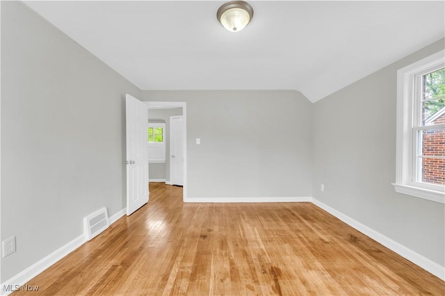 563 E 260th St, Euclid, OH 44132 - empty room featuring baseboards, light wood-type flooring, and vaulted ceiling